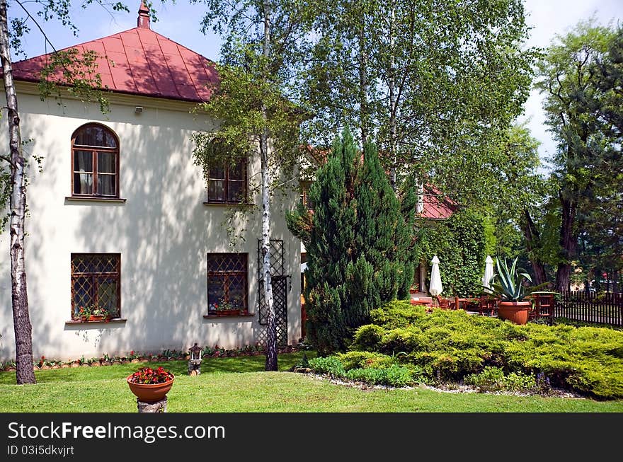 House and ornamental garden in the midday sun. House and ornamental garden in the midday sun.