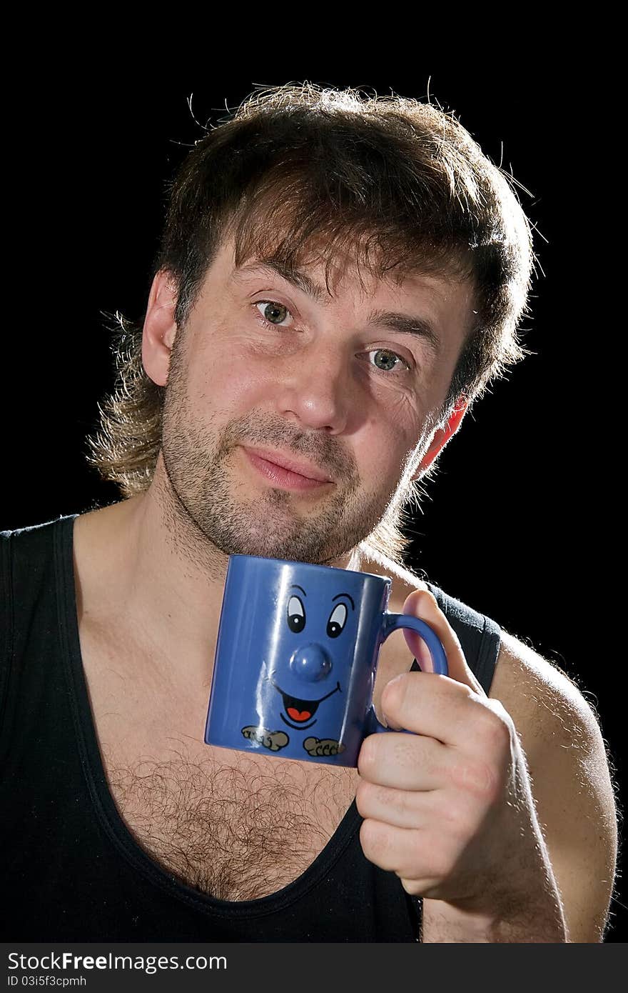 The man with a dark blue mug on a black background