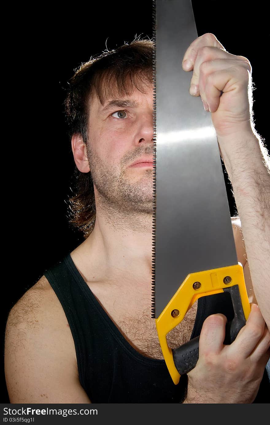 The man with the tool on a black background