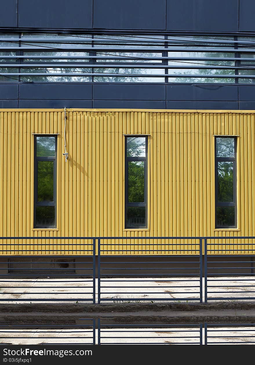 Yellow wall with windows and videocamera