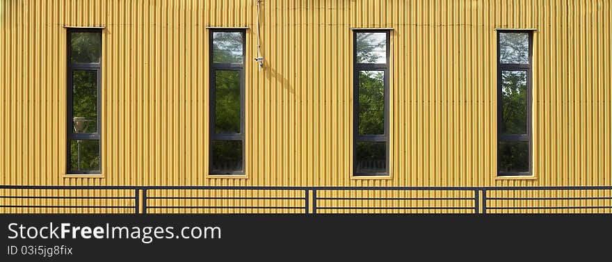 Yellow wall with windows and videocamera