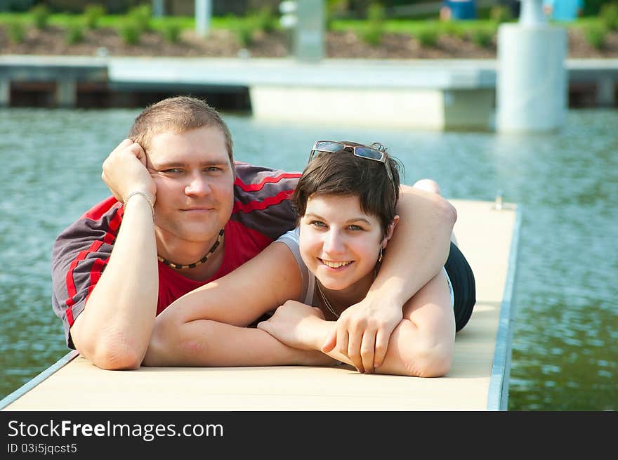 Young pair on harbor pier