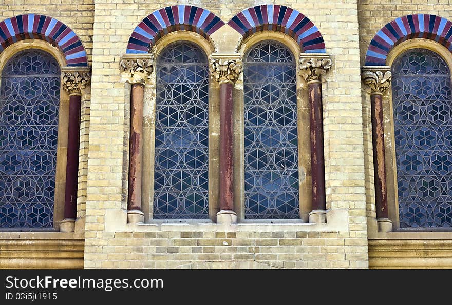 Four arched, leaded church windows with arched tops and pillars