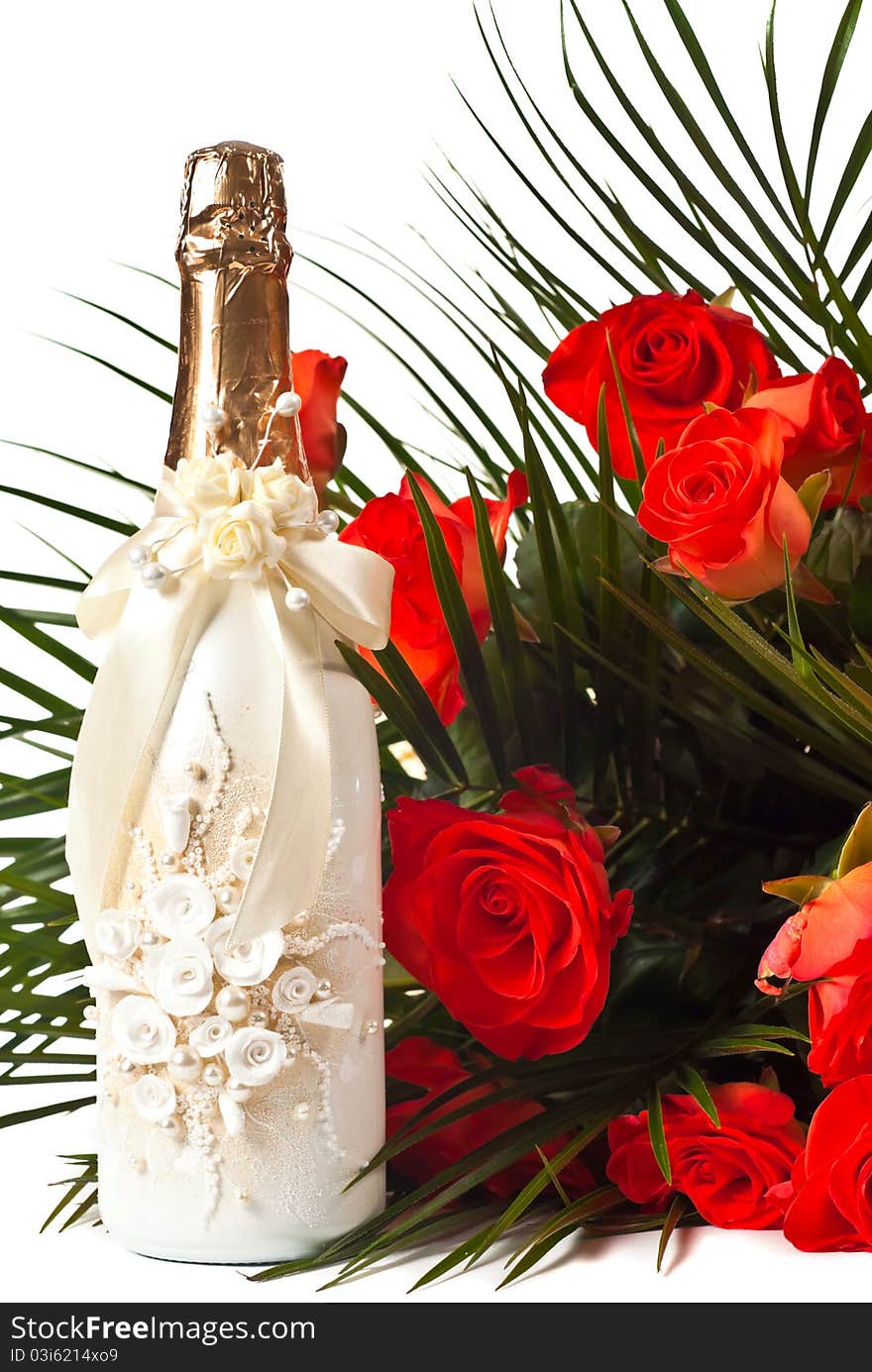 Red roses and champagne isolated on white.