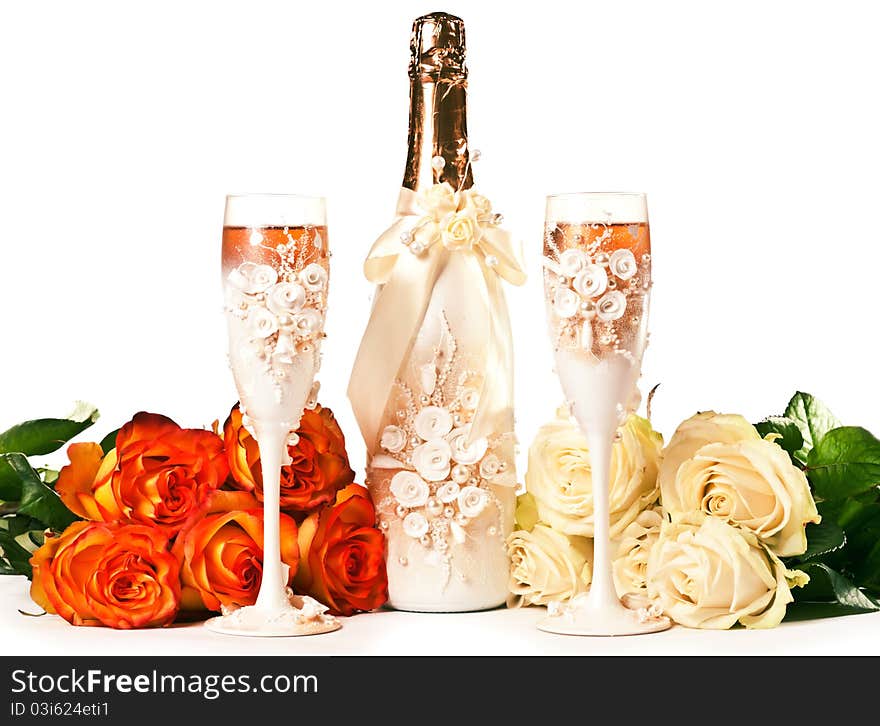 Two glasses of celebratory champagne with white roses. Two glasses of celebratory champagne with white roses