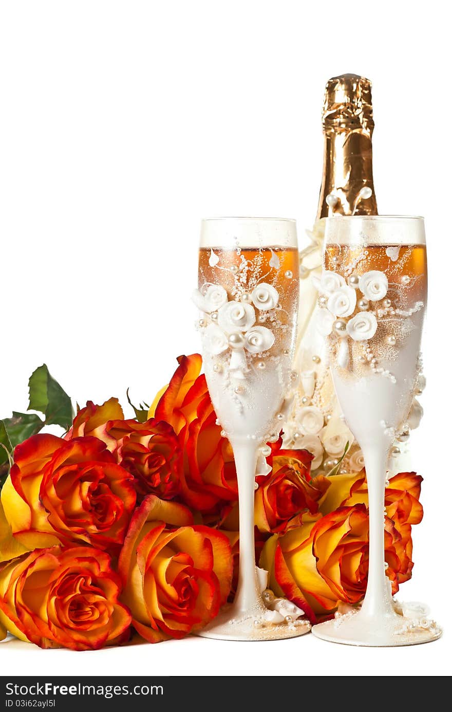 Two glasses of champagne and a roses against white background. Two glasses of champagne and a roses against white background.