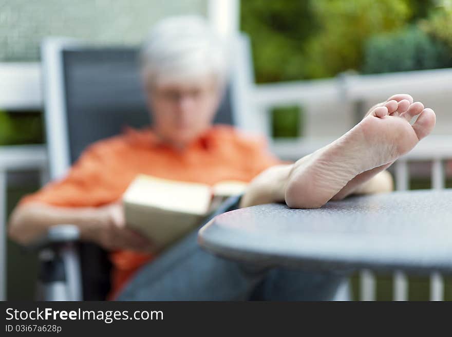 Woman sitting on the balcony and read a book. Woman sitting on the balcony and read a book