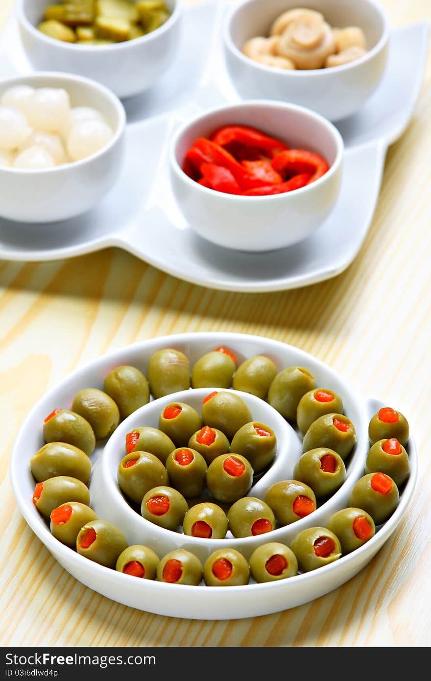 Stuffed green olives on ceramic plate