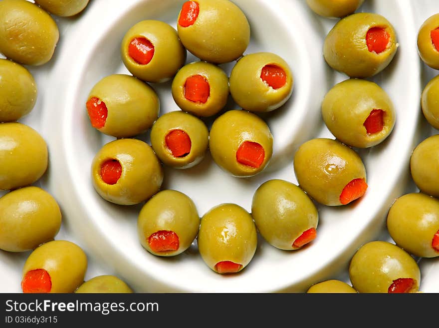 Stuffed green olives on ceramic plate