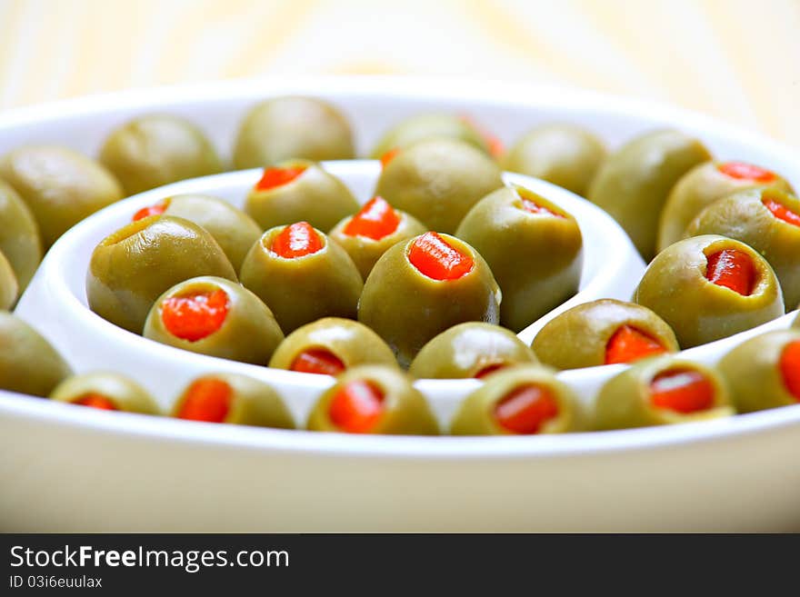 Stuffed green olives on ceramic plate