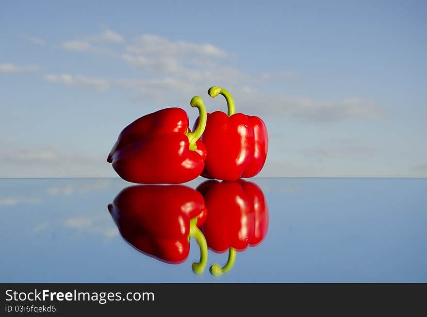 Two red peppers on mirror