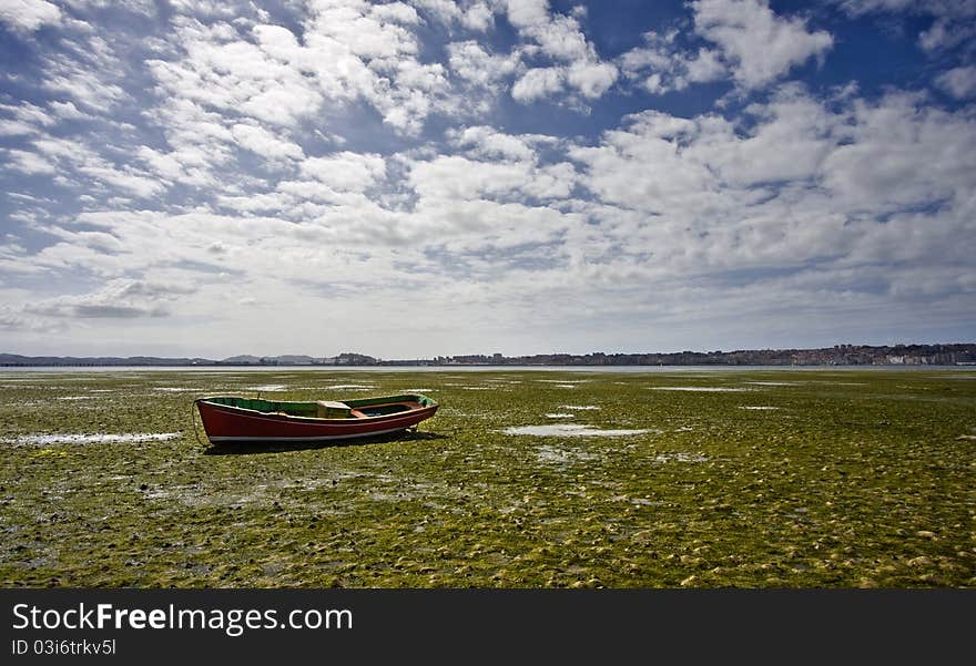 Small boat stranded in the mud. Small boat stranded in the mud