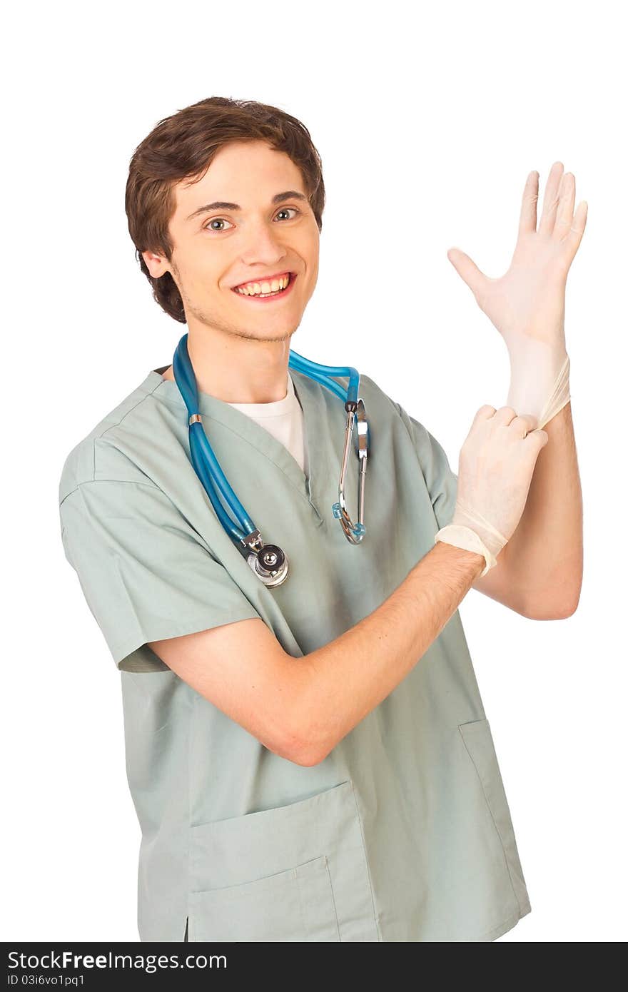 Happy young medical worker standing putting on gloves on white background. Happy young medical worker standing putting on gloves on white background