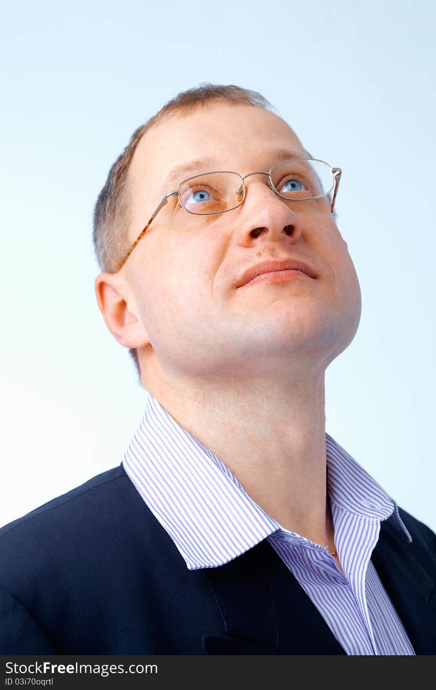 Portrait of a confident young man looking up through glasses. Portrait of a confident young man looking up through glasses.