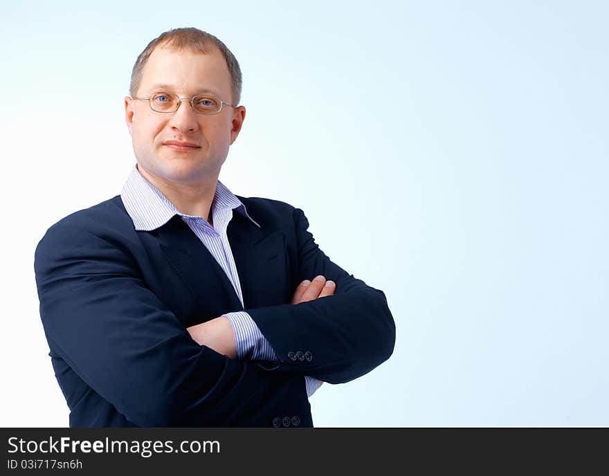 Close up portrait of a man standing with glasses,his hands folded. Close up portrait of a man standing with glasses,his hands folded.