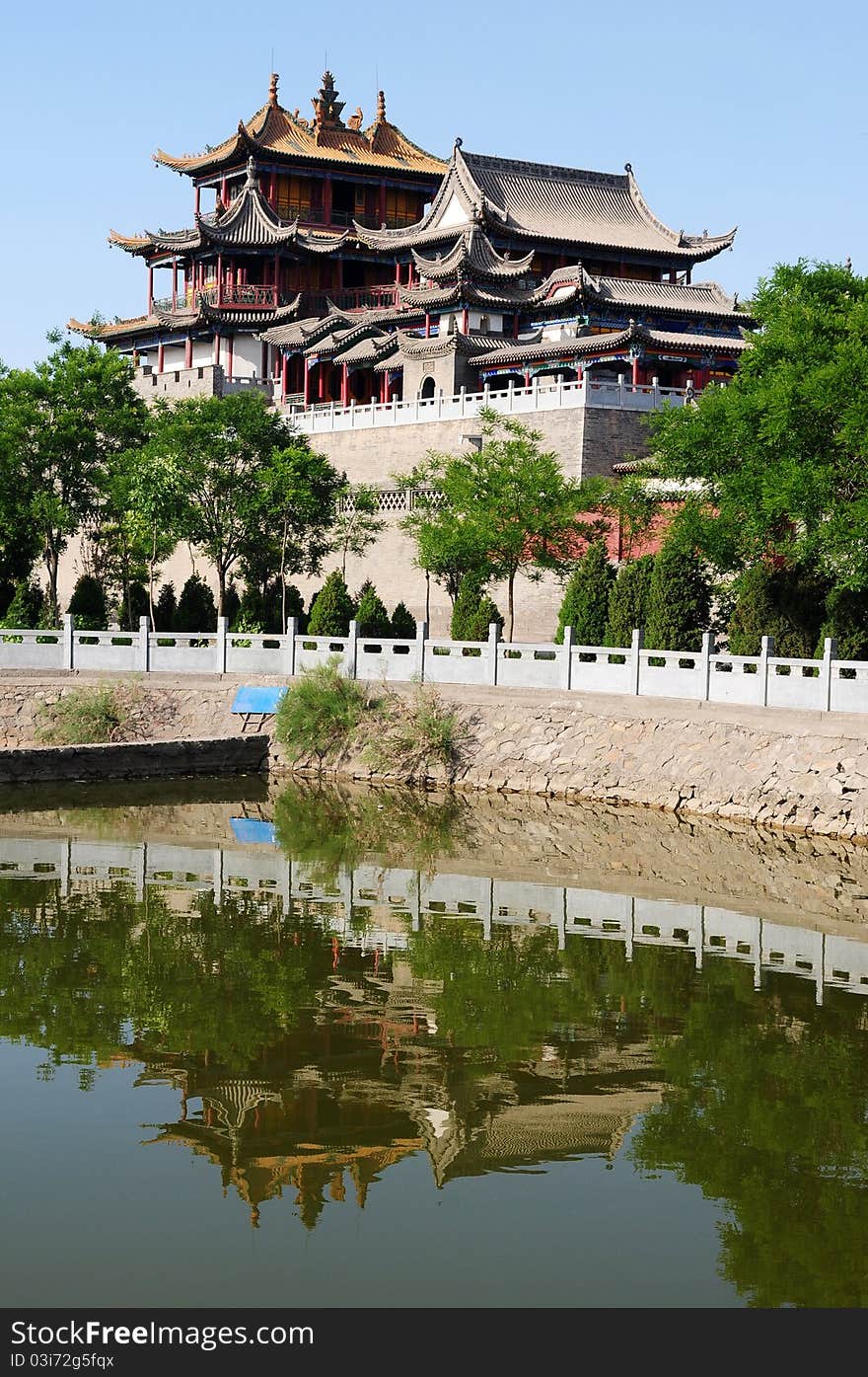 A typical Chinese ancient temple with a mirror in the water