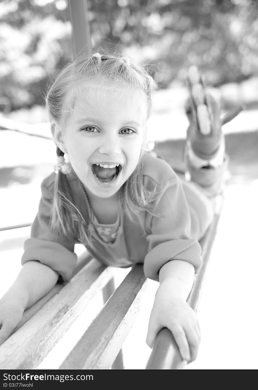 Cute little girl smiling in a park close-up