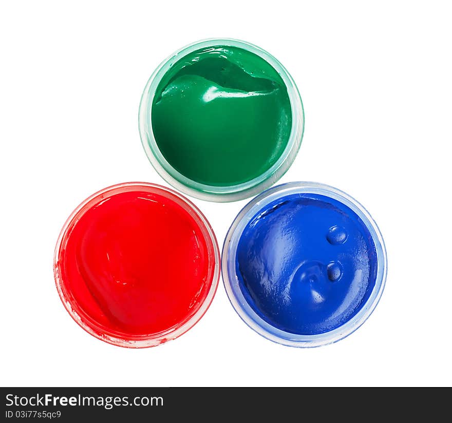 Closeup view of red, green and blue cans with gouache