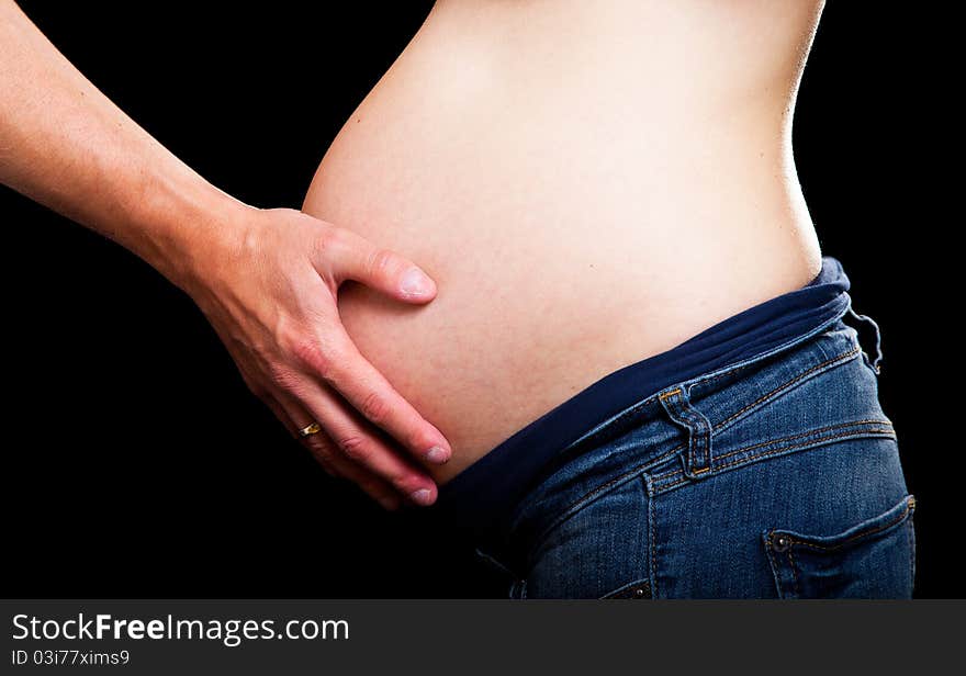 Pregnant woman on black