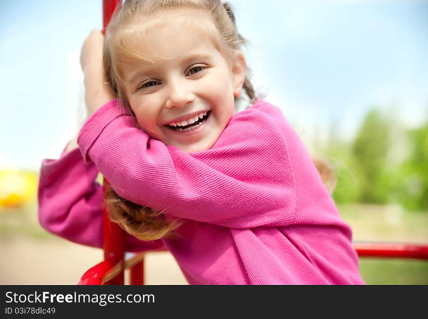 Cute little girl smiling in a park close-up