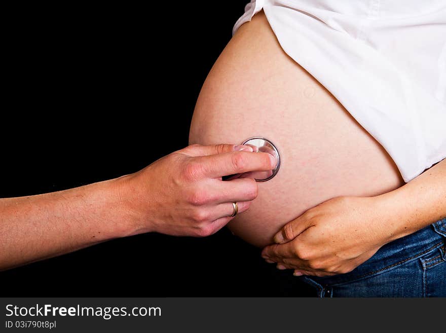 Pregnant woman on black