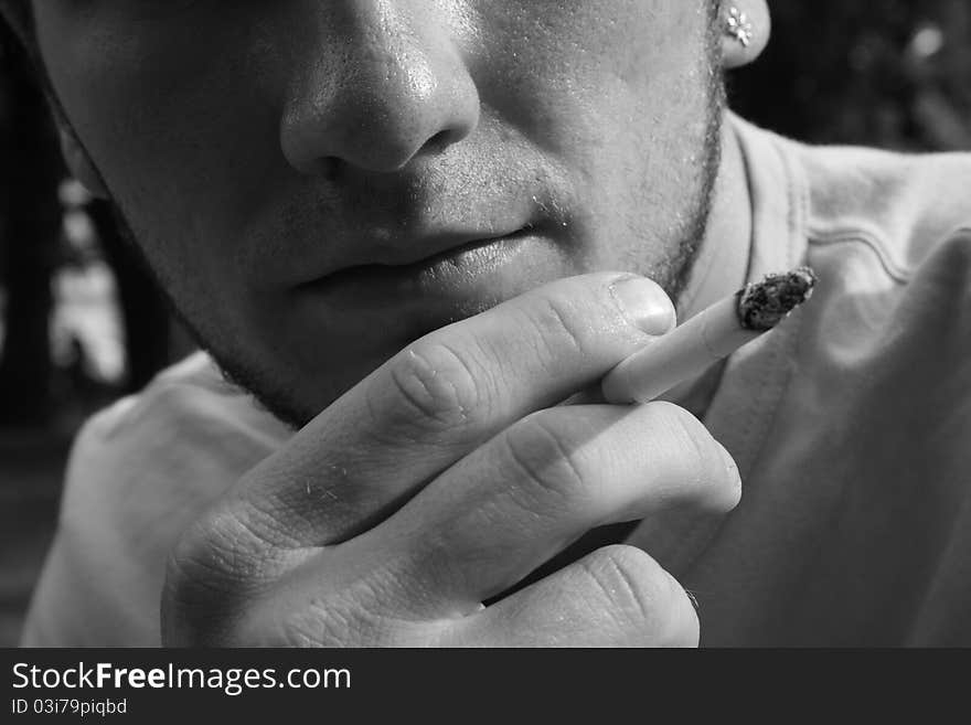 Caucasian man holding a cigar