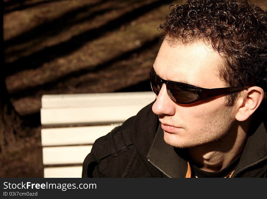 Outdoor portrait of young handsome man with sunglasses