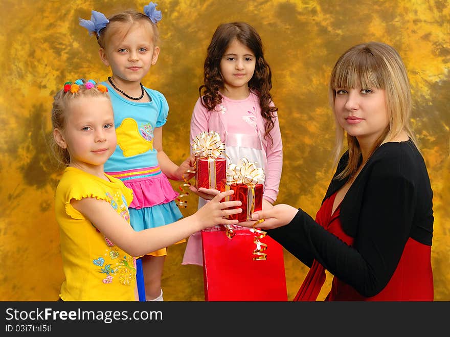 Young Woman Give Gifts To The Children