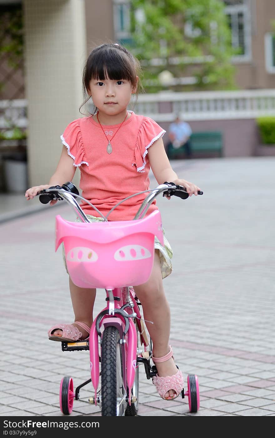 Asian Child Riding A Bicycle