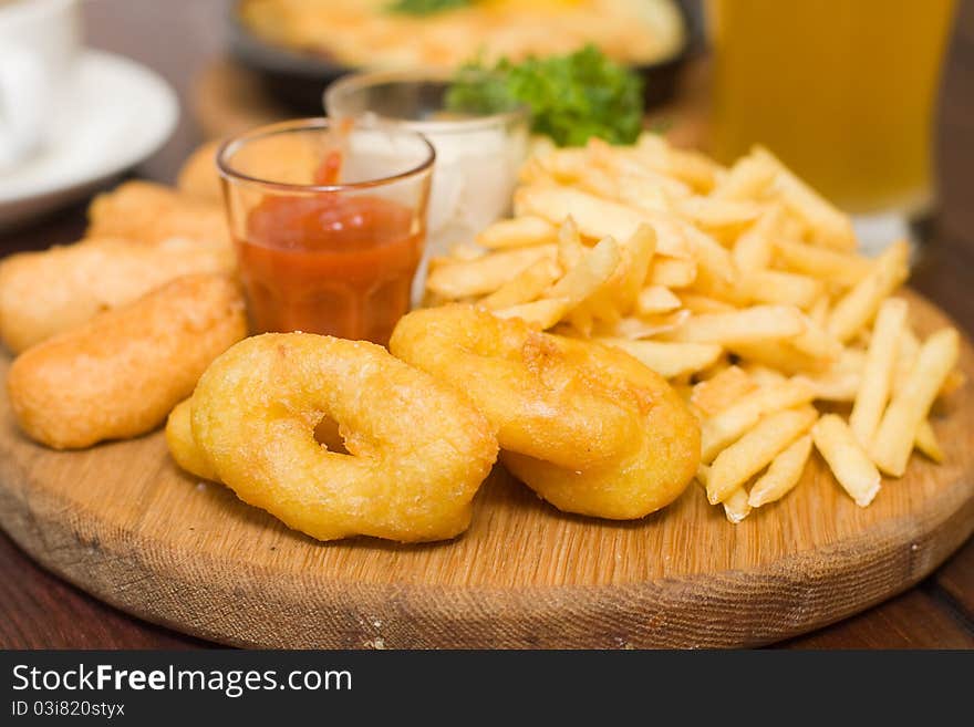 Snack - fried potatoes and squid in restaurant