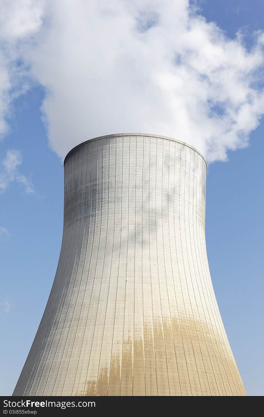 Big smokestack of nuclear factory with blue sky. Big smokestack of nuclear factory with blue sky