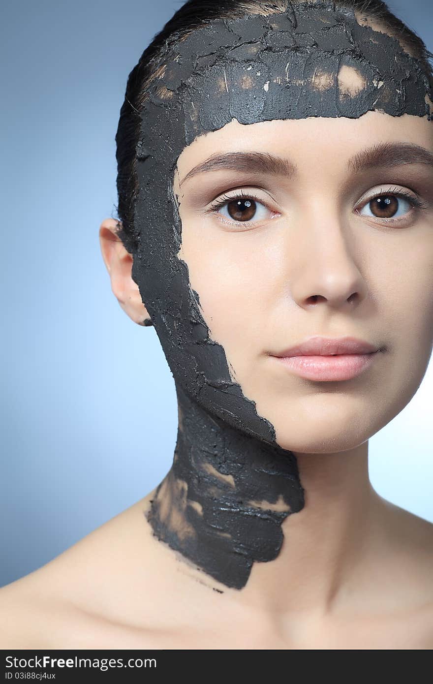 Portrait of a woman with spa mud mask on her face. Portrait of a woman with spa mud mask on her face.