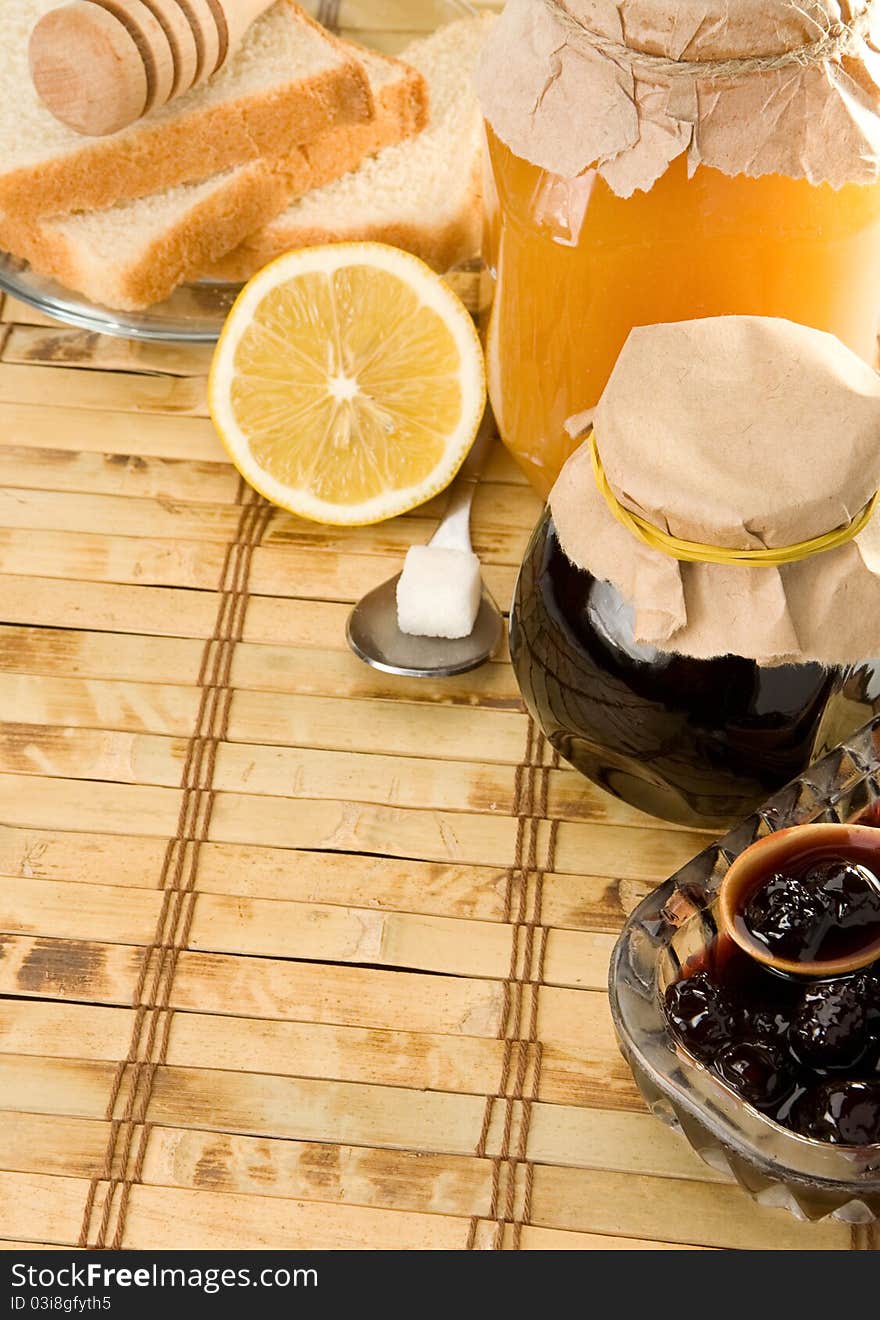 Coffee, honey and bread on straw table. Coffee, honey and bread on straw table