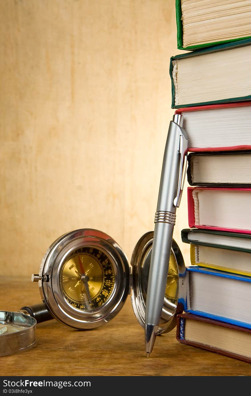 Pile of books and pens on wood