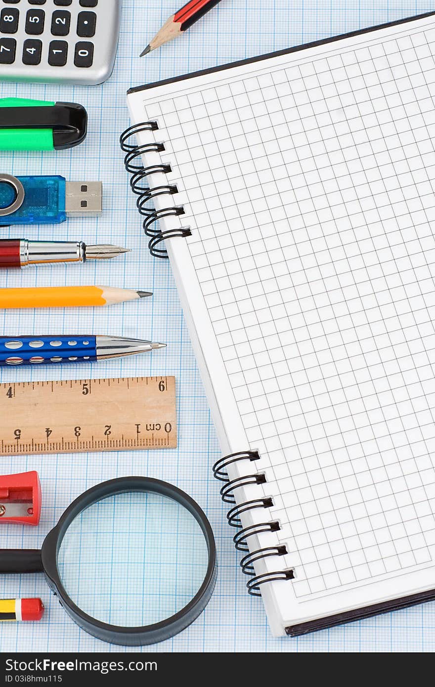 School accessories and checked notebook on graph grid paper