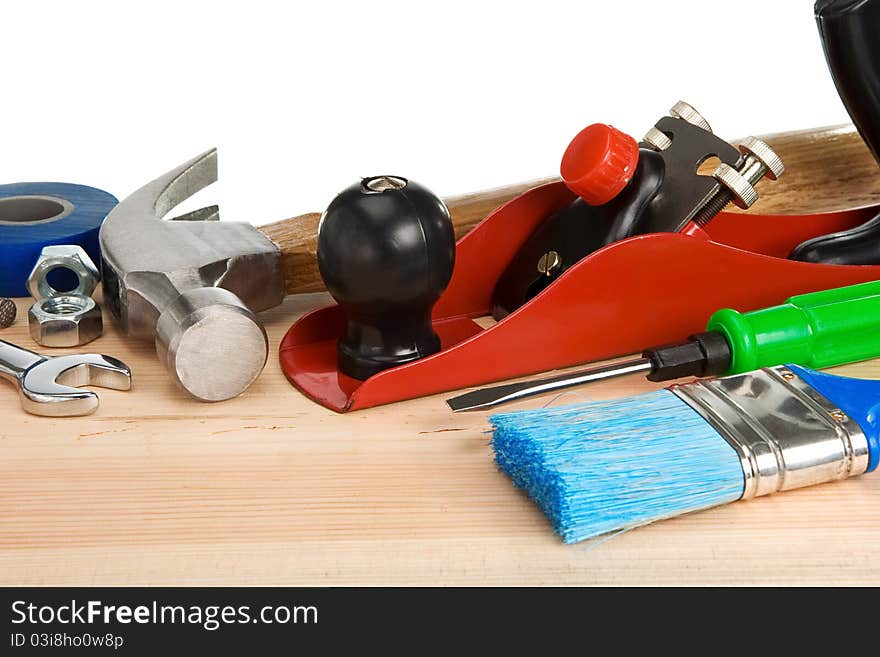 Tools and instruments isolated at white on wooden texture