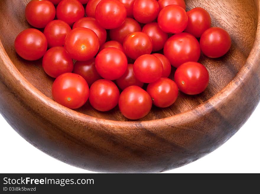 Many red cherry tomatoes in wooden bowl. Many red cherry tomatoes in wooden bowl