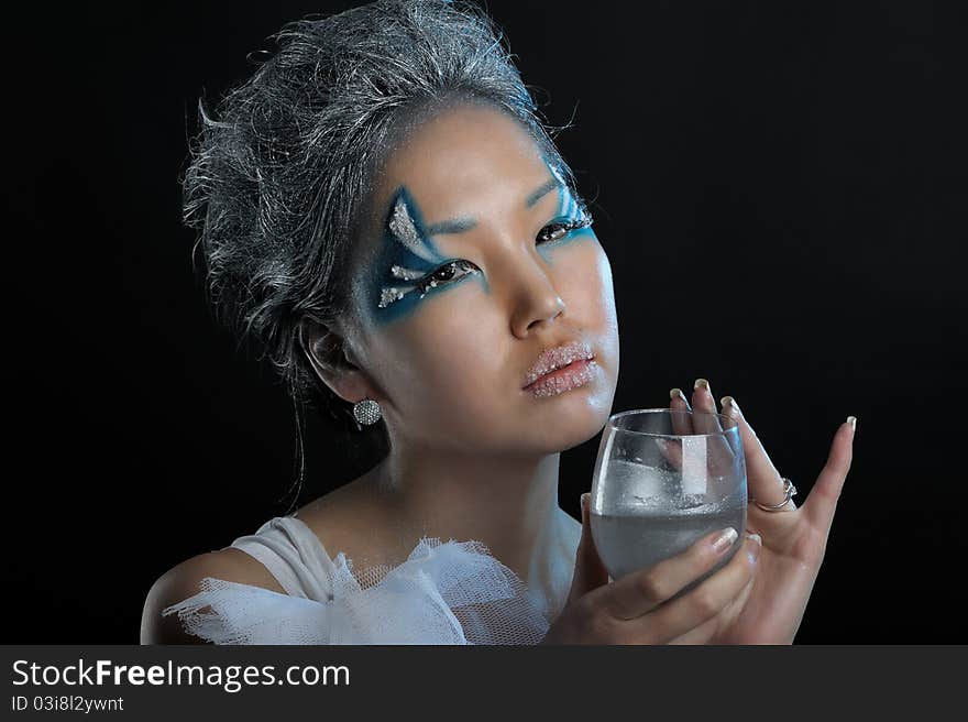 Portrait of woman with creative makeup and wineglass in her hands. Portrait of woman with creative makeup and wineglass in her hands