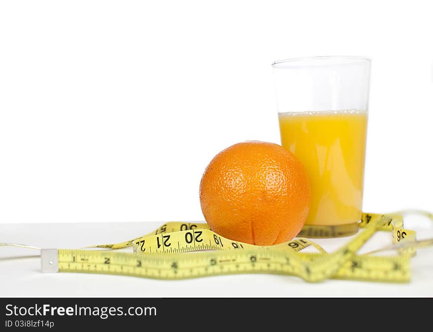 Oranges and orange juice with measuring tape