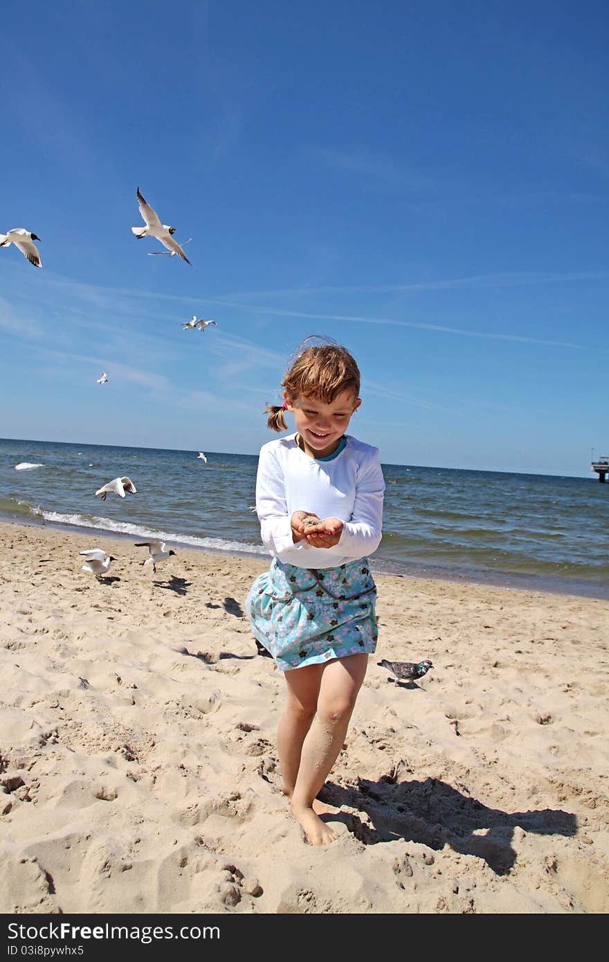 Girl playing on the beach. June 2011 - Miedzyzdroje