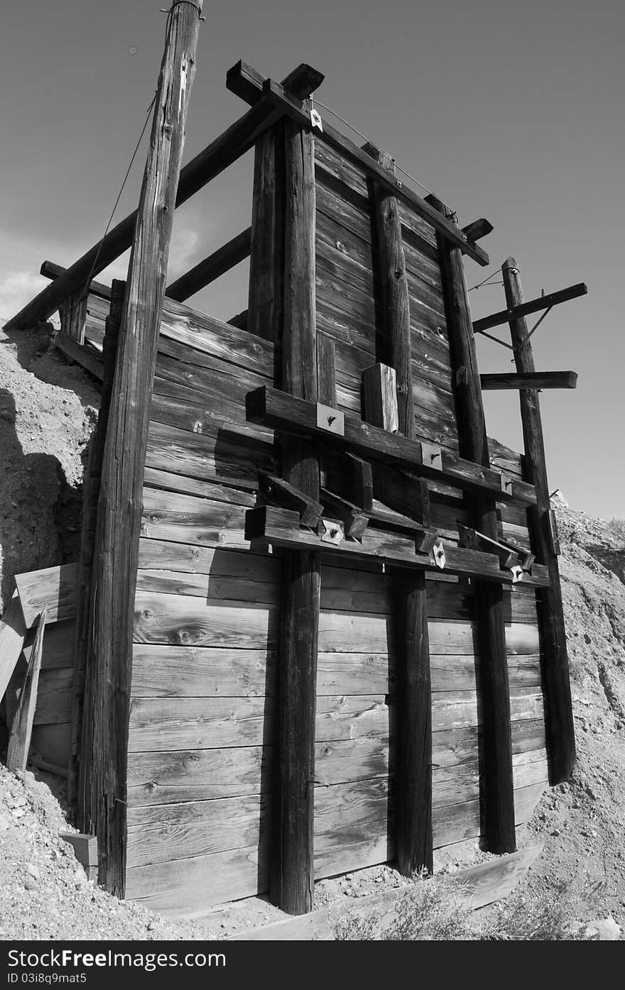 Abandoned mining structure stands tall in the desert.