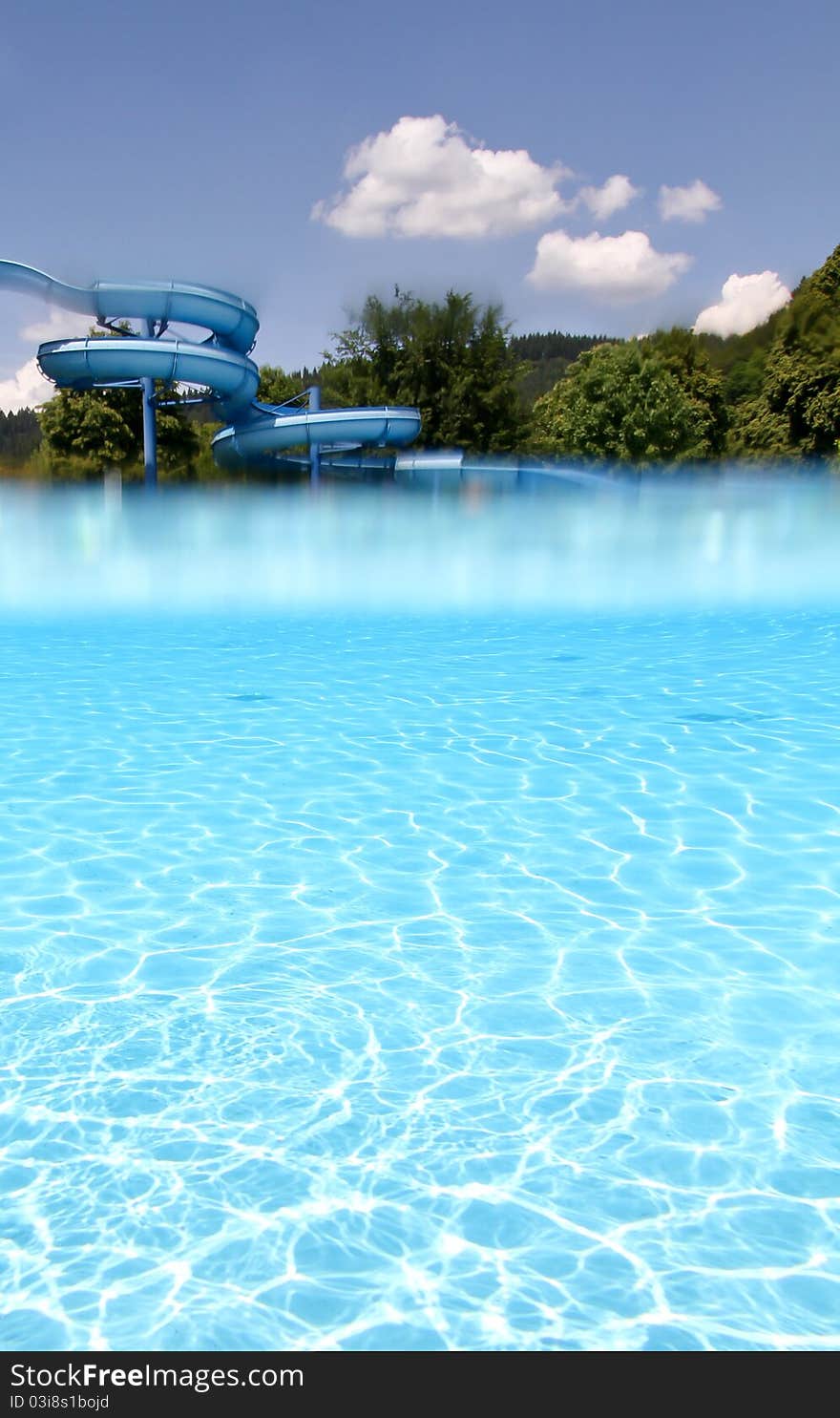 Waterslide and underwater pool in blue sky