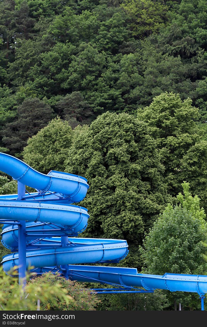 Blue water slide in forest