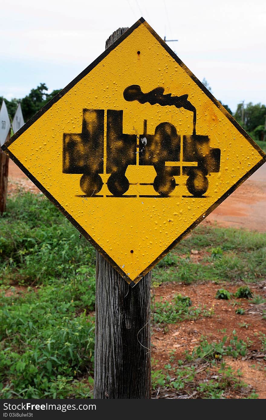 The sign train beside the railway.