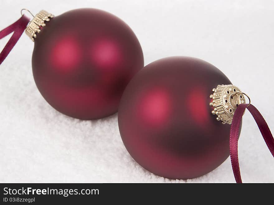 Two Christmas Ornament on a Snow background