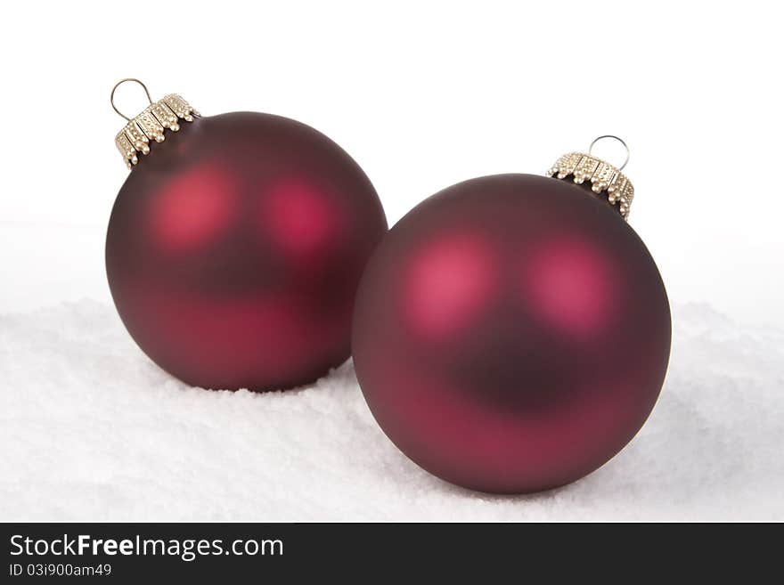 Two Red Christmas Bauble on a Snow background. Two Red Christmas Bauble on a Snow background