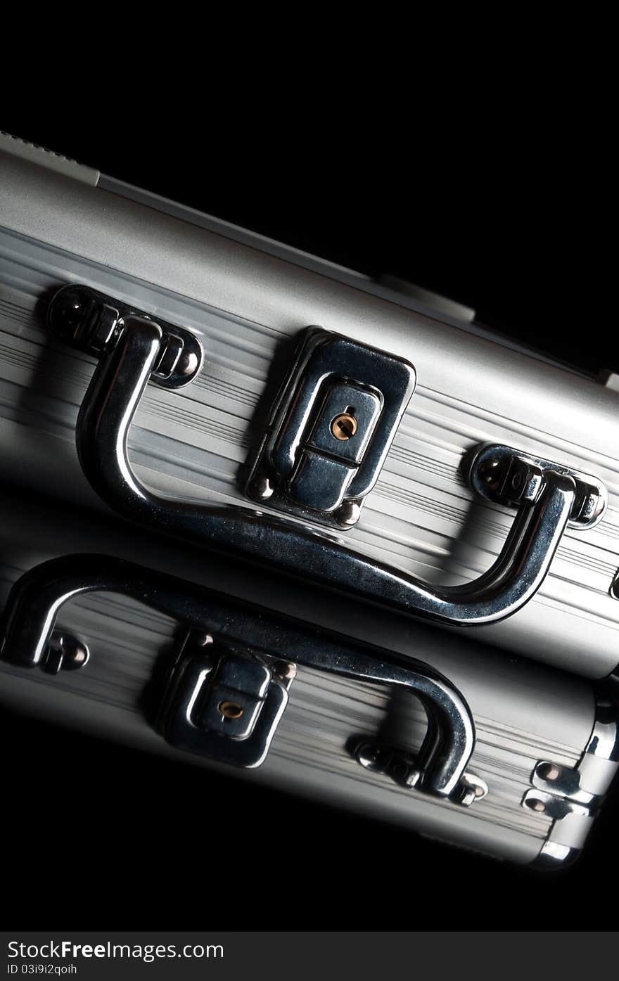 Silver suitcase isolated on a black background