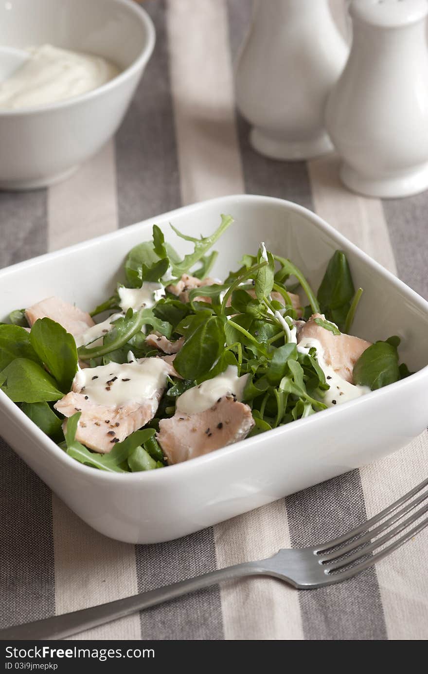 Salmon with watercress and creme fraiche in a bowl. Salmon with watercress and creme fraiche in a bowl