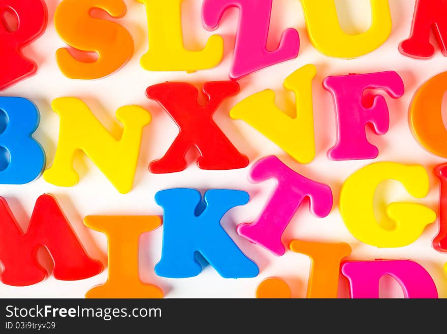 Multicolored toy letters - abstract education background. Multicolored toy letters - abstract education background