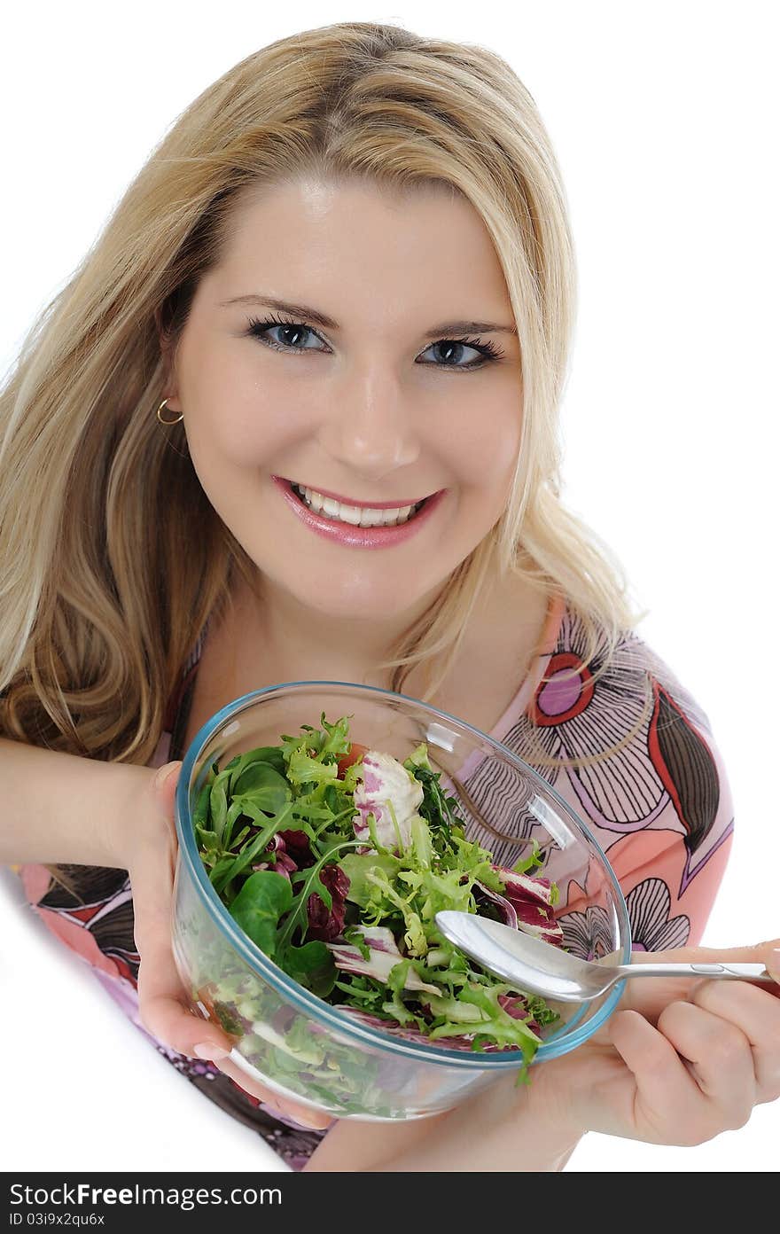 Beautiful woman eating green vegetable salad. isolated on white